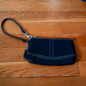 Black leather "Coach" Wristlet in good condition.